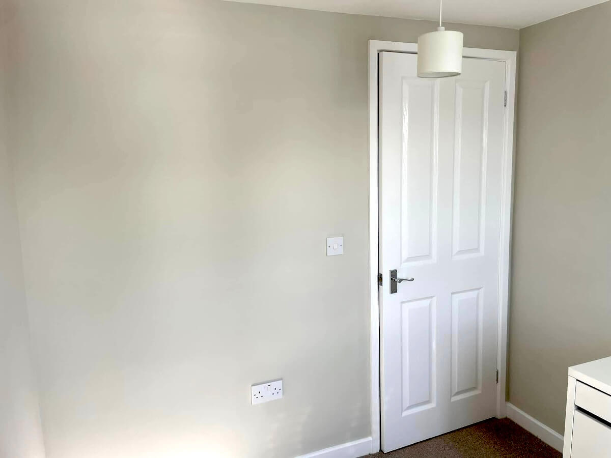 bedroom-grey-painted-walls-empty-pendant-light-cardiff-primrose-decor Finished grey painted bedroom wall with a white door in Cardiff