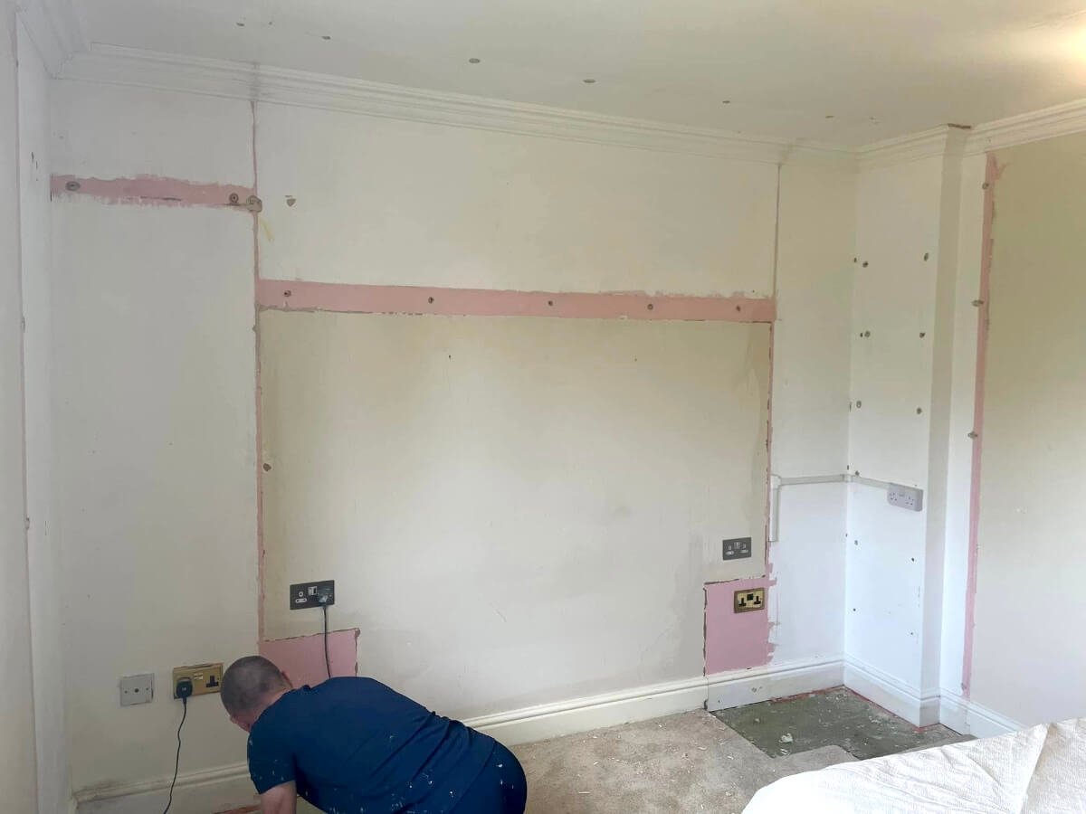 Painter preparing plasterboard walls in Cardiff by Primrose Decor decorators
