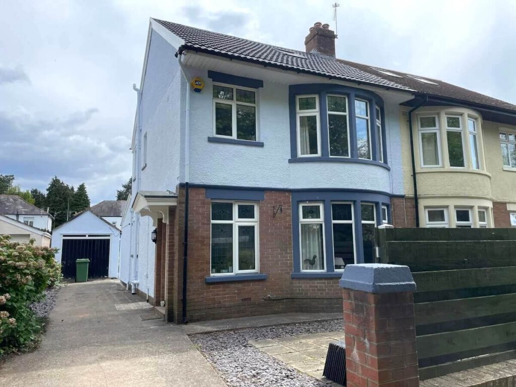 Painted exterior walls and window frames on a semi-detached house