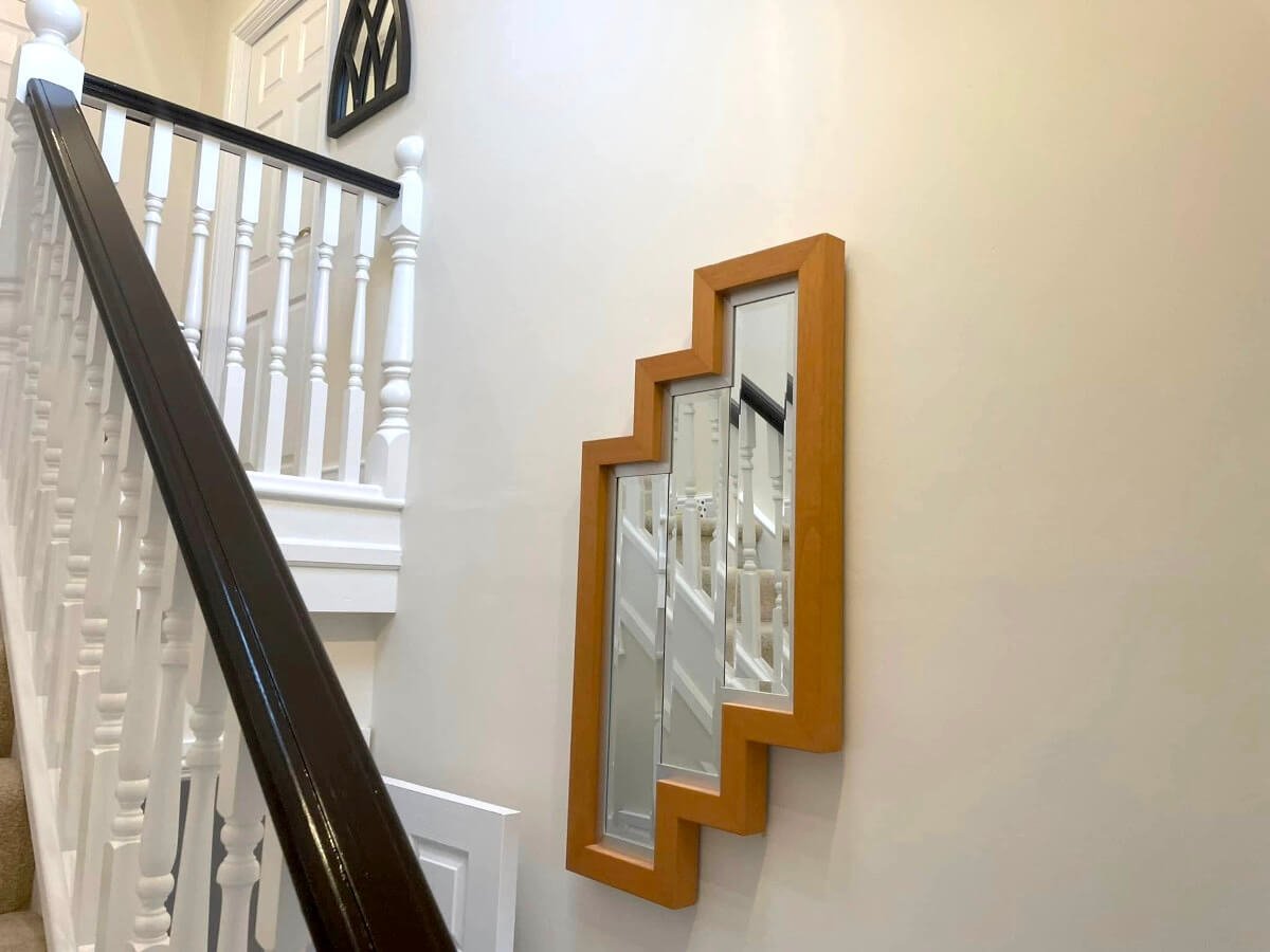 Hallway with cream painted walls and stairs in Cardiff by Primrose Decor
