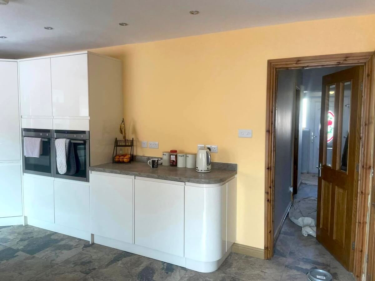 Cream and yellow painted kitchen walls with white cabinets, Cardiff cabinet painting by Primrose Decor