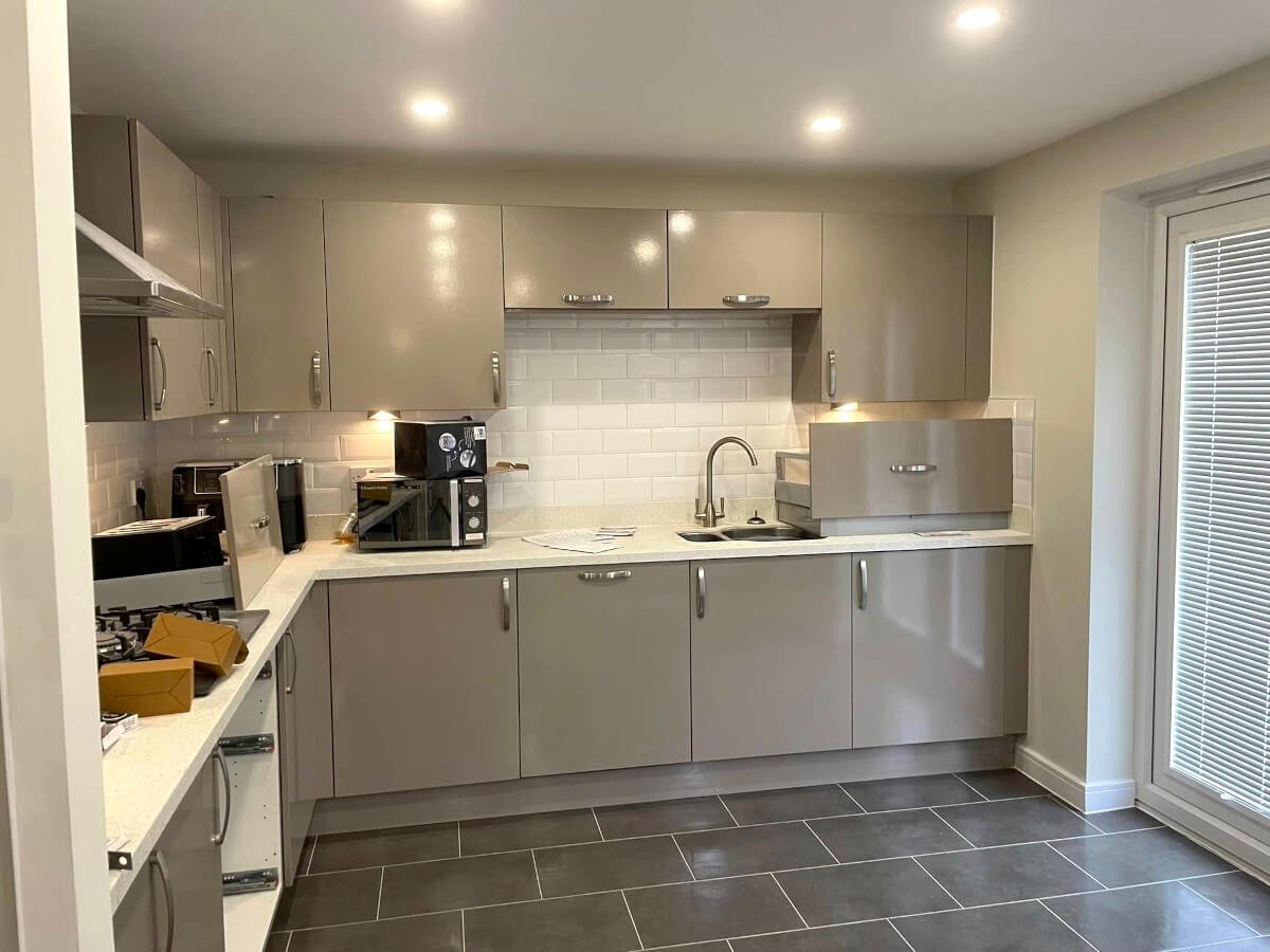 Kitchen cabinet painting in Cardiff by Primrose Decor, grey painted cabinets with subway tile backsplash
