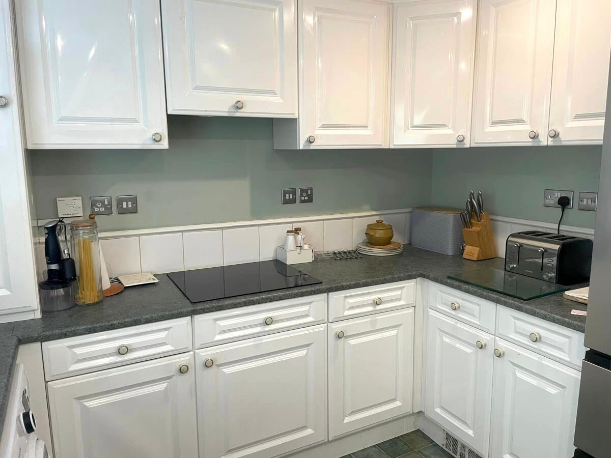White painted kitchen cabinets with green tile backsplash, Cardiff kitchen cabinet painting by Primrose Decor