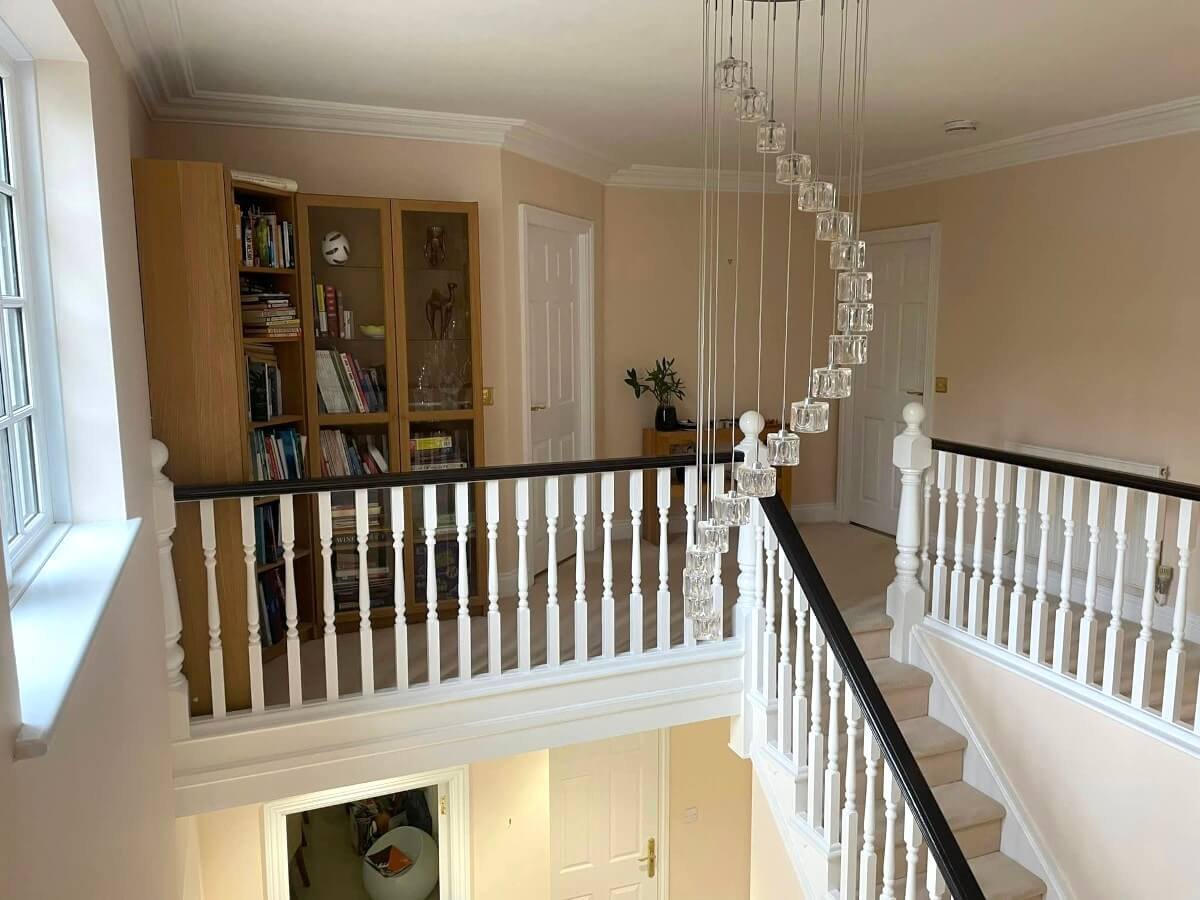 landing-beige-painted-walls-bookshelf-chandelier-cardiff-primrose-decor Beige painted landing walls with bookshelf and chandelier in Cardiff home by Primrose Decor