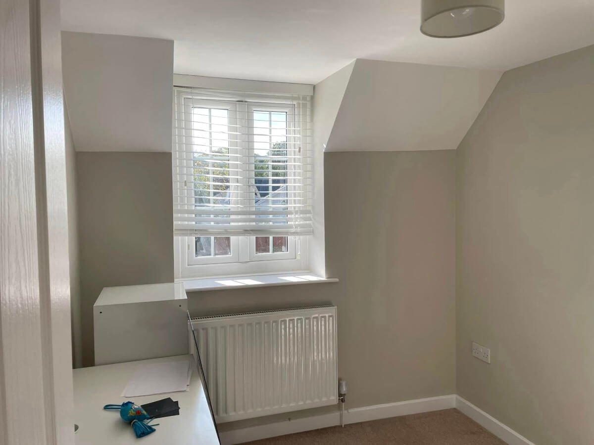 Loft bedroom with grey painted walls and window seat in Cardiff by Primrose Decor