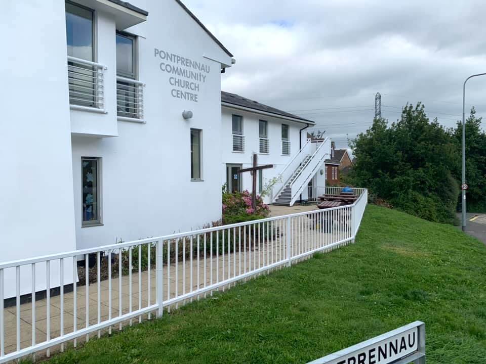 Painted exterior of a community building with an access ramp